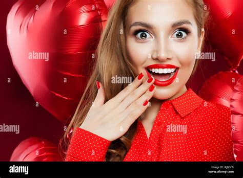 Surprised Woman With Red Lips Makeup And Manicured Hand On Red Heart