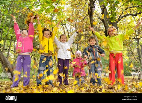 Kids Playing With Leaves Stock Photo Alamy