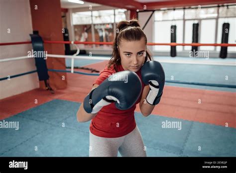 Close Up Of A Young Female Kick Boxer With Boxing Gloves Punching