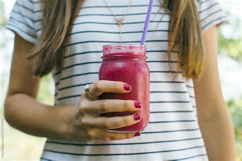 Female Holding A Homemade Purple Smoothie In A Mason Jar By Stocksy Contributor Carolyn