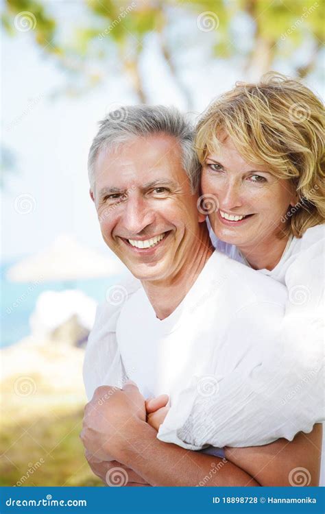 Mature Couple Smiling And Embracing Stock Photo Image Of Background