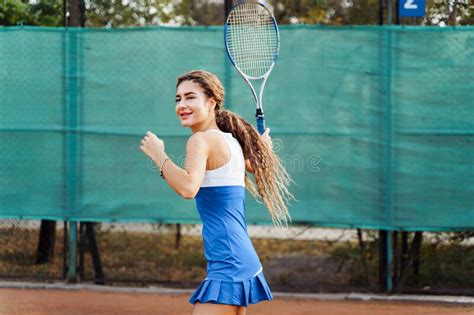 Beautiful Young Woman Athlete Enjoys Spending Time On The Tennis Court Powerful Blow Forehand