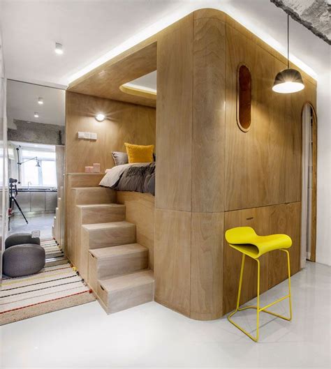 A Room That Has Some Stairs And Yellow Stools In Front Of The Bed Area