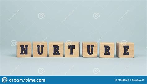 The Word Nurture Made From Wooden Cubes On Blue Background Stock Image