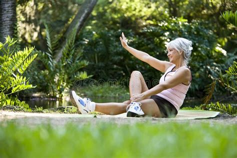 Woman On Mat Doing Stretching Exercises Outdoors Stock Image Image Of