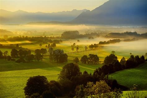 Breathtaking Morning Lansdcape Of Small Bavarian Village Covered In Fog