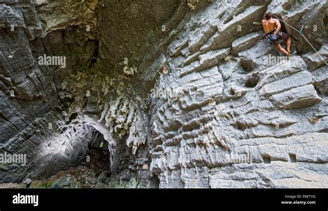 Male Climber Climbing Treasure Cave In Yangshuo Guangxi Zhuang China
