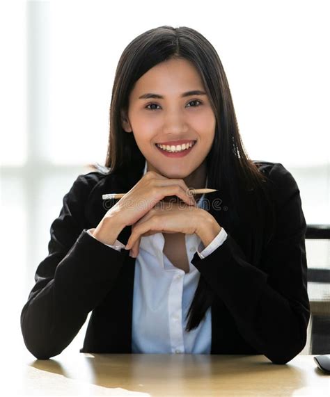 Beautiful Asian Woman Holding Pencil Sitting And Working Alone With