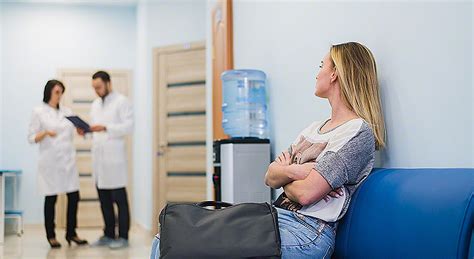 Woman Patient Waiting At Hospital Doctors Waiting Room Via Modem