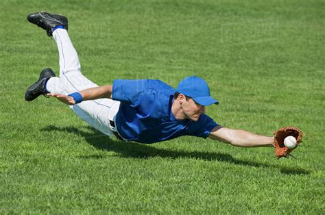 Baseball Player Diving To Catch Baseball Stock Photo Dissolve