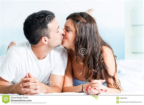 young couple kissing  bedroom stock photo image  kissing home