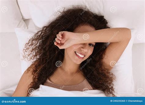 Happy African American Woman Awakening In Bed Top View Stock Image