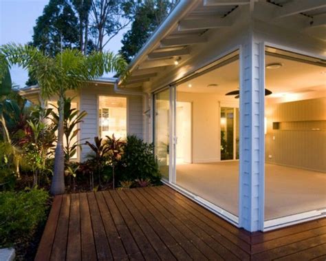 Glossy floors and surfaces, neutral colours from black, to pale beige shades, white and grey create a sophisticated living space. Tropical Modern Lanai | House exterior, Outside living ...