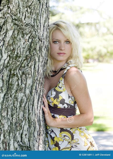 Young Blond Teen Girl Outdoors Next To Tree Royalty Free Stock Images