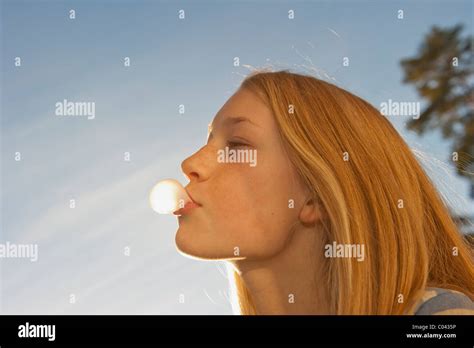 Teenage Girl Blowing A Bubblegum Bubble Stock Photo Alamy