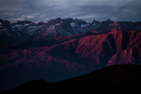 A Red Hued Shot Of A Mountainous Landscape With Numerous Snow Capped