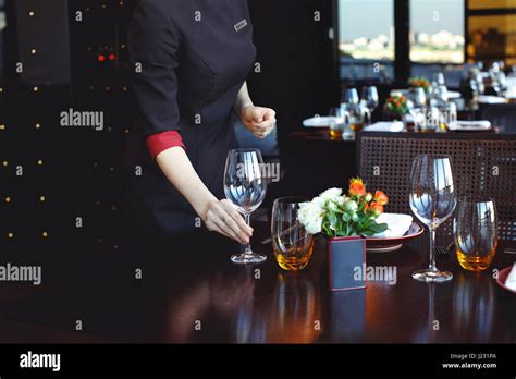 Waiter Serving Table In Restaurant Stock Photo Alamy