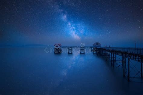 Vibrant Milky Way Composite Image Over Landscape Of Old Pier Stretching
