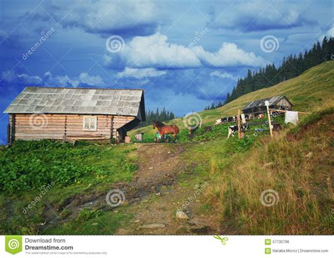 Traditional Mountain House On Green Field In A Village Stock Photo