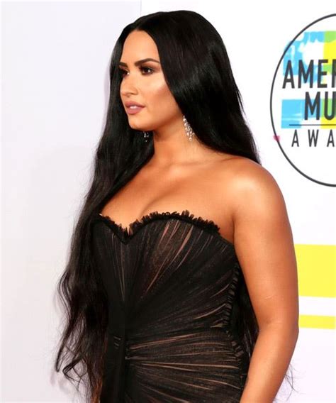 Black pants and black boots. Demi Lovato Long Straight Black Hairstyle