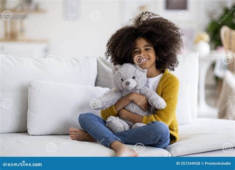 Happy African American Preteen Girl Embracing Teddy Bear Stock Photo