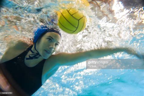 Professional Female Water Polo Player Dribbling The Ball High Res Stock