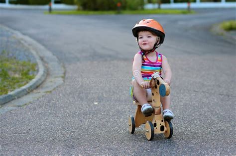 Little Girl Riding Wooden Tricycle On The Street Stock Image Image Of