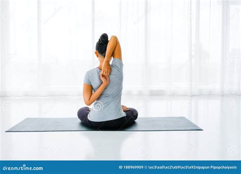 Female Doing Stretching Exercises Yoga Hands Behind Back Sitting In