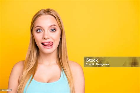 Portrait Of Lovely Blond Girl Licking Upper Lip With Tongue Out And