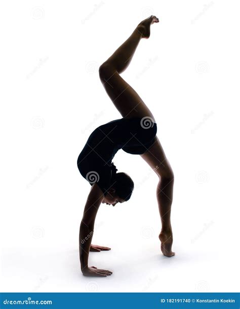 Graceful Gymnast In Sportswear Performs A Handstand Training Element