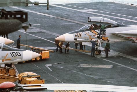 Crewmen Service An F 14 Tomcat From VF 142 On The Flight Deck Of The