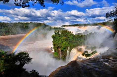 Sunbeams Create A Lot Of Rainbows In The Mist Above The Falls Iguazu