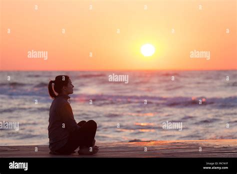Profile Of A Woman Silhouette Watching Sun On The Beach At Sunset Stock