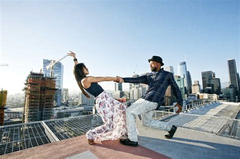 Couple Dancing On Urban Rooftop Stock Photo