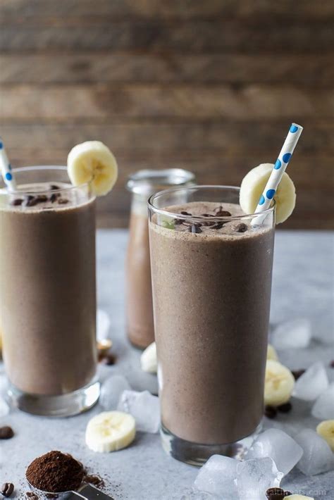 Two Glasses Filled With Chocolate Milkshakes And Banana Slices