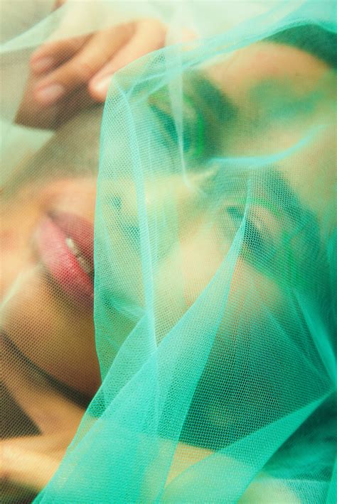 woman with birth mark with green tulle on her face photos by canva