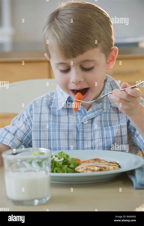 Boy Eating Dinner Stock Photo Alamy