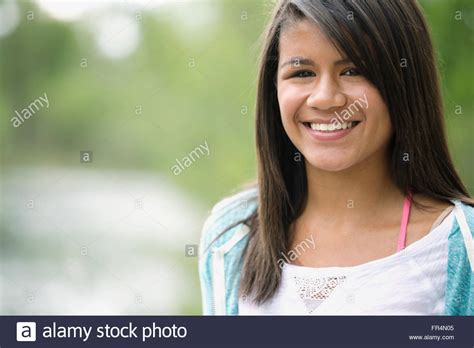 Portrait Of Pretty Middle School Student Sitting Outdoors Stock Photo