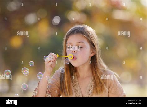 Young Girl Blowing Bubbles Outdoors Stock Photo Alamy