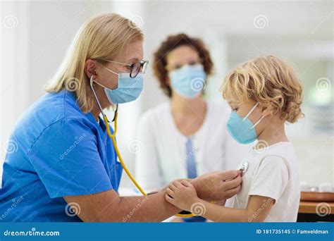 Doctor Examining Sick Child In Face Mask Stock Image Image Of