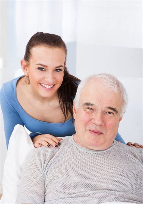 Portrait Of Happy Caregiver With Senior Man Stock Photo Image 56909190