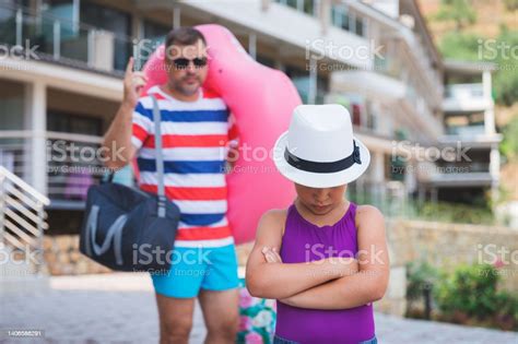 Father Scolding His Daughter On Their Way To Beach Stock Photo