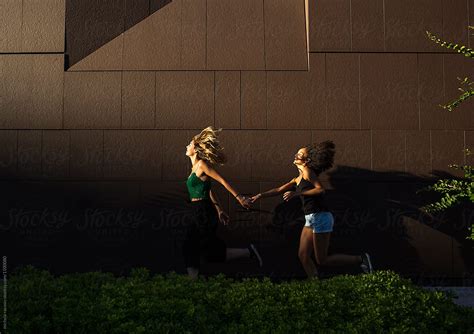 Two Girls Run Away Together By Stocksy Contributor Michela Ravasio