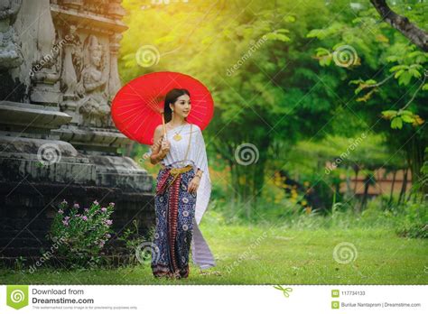 Beautiful Thai Girl In Traditional Dress Costume Red Umbrella As Stock
