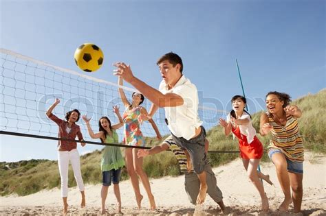 Group Of Teenage Friends Playing Volleyball On Beach