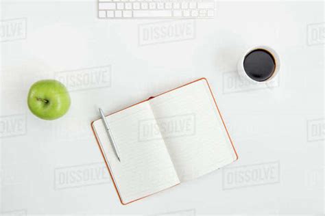 Top View Of Blank Open Notebook With Pen Cup Of Coffee Green Apple