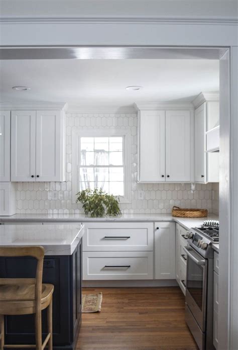Modern farmhouse white kitchen with black hardware #kitchen #kitchendecor #kitchendecorideas #kitchendecorating #kitchendecoratingideas white beveled brick tiles create a lustrous backsplash display paired with white quartz countertops, white raised panel cabinets accented with bronze. 25 Photos Of Our New Kitchen Because I Love It That Much ...