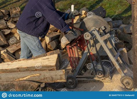 Sawing Firewood With Circular Saw Man Cutting Fuelwood On A Large