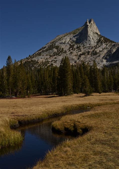 A Calm Stream Leading To A Jagged Spire Of Granite Cathedral Peak