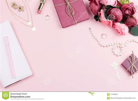 Woman Fashion Accessories Flowers Cosmetics And Jewelry On Pink